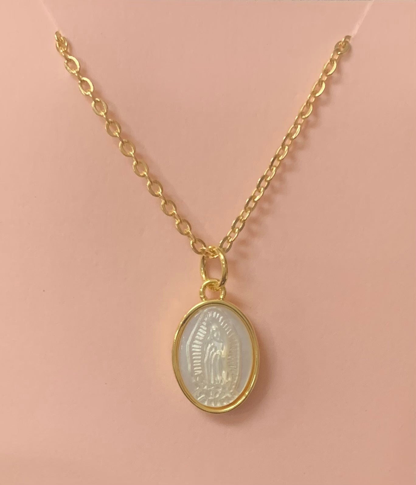 Our Lady of Guadalupe medal on a mother-of-pearl background with a gold filled chain